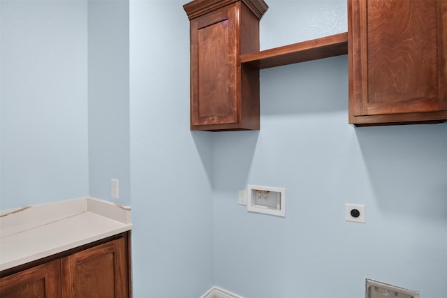 clothes washing area with hookup for an electric dryer, hookup for a washing machine, and cabinets