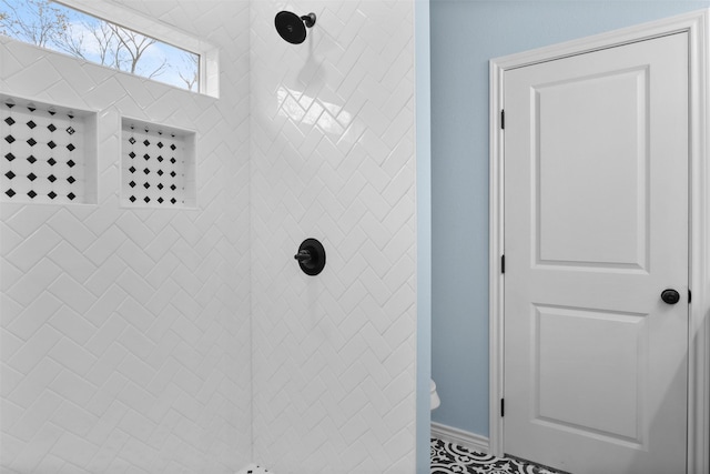 bathroom with a tile shower