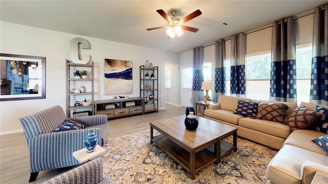 living room with ceiling fan and light wood-type flooring