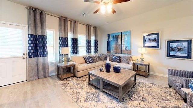 living room featuring light hardwood / wood-style floors, ceiling fan, and lofted ceiling