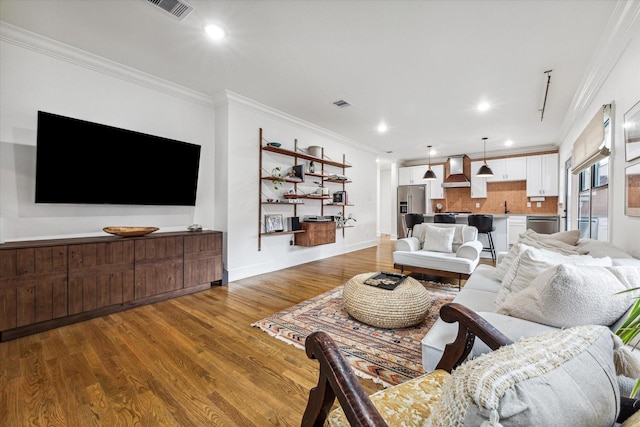 living room featuring wood-type flooring and ornamental molding