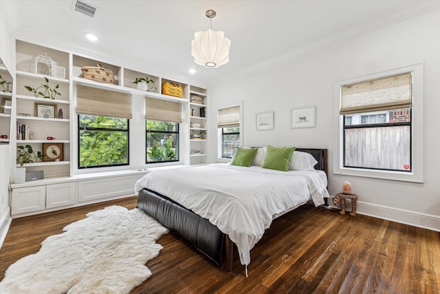 bedroom with dark hardwood / wood-style floors and ornamental molding