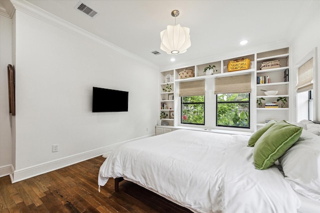 bedroom with crown molding and dark wood-type flooring