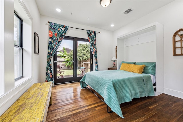 bedroom featuring french doors, access to outside, multiple windows, and dark hardwood / wood-style floors