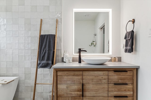 bathroom with vanity and tile walls