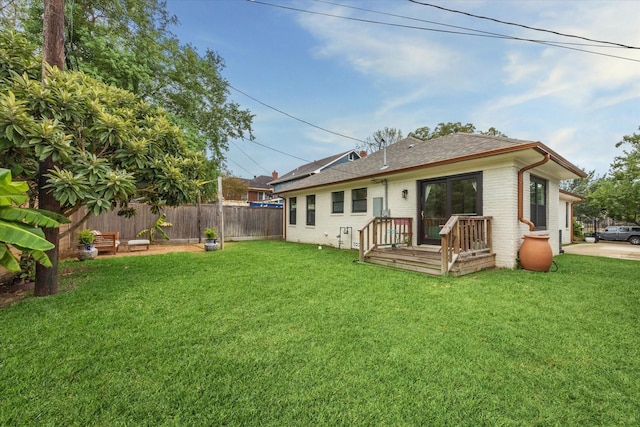 rear view of house featuring a lawn