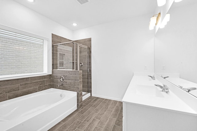 bathroom featuring separate shower and tub and vanity