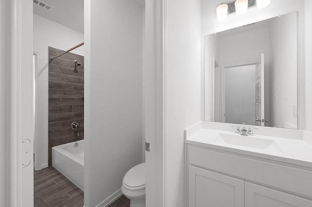 full bathroom with tiled shower / bath combo, toilet, and vanity