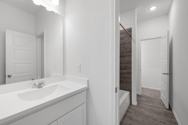 bathroom with vanity, tiled shower / bath combo, and hardwood / wood-style flooring