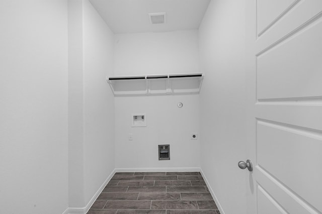 clothes washing area featuring gas dryer hookup, hookup for a washing machine, dark hardwood / wood-style floors, and hookup for an electric dryer