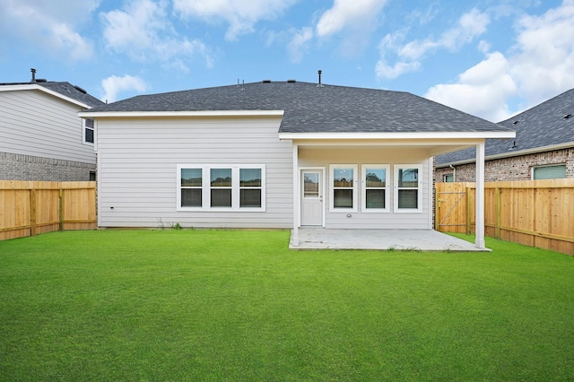 back of property with a patio area and a yard