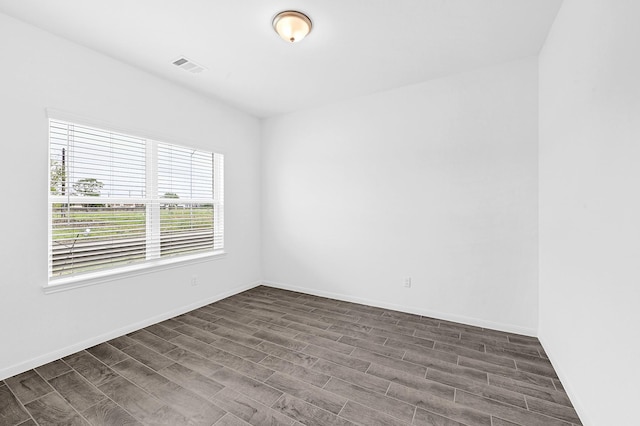 unfurnished room with dark hardwood / wood-style flooring