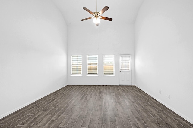 unfurnished living room with dark hardwood / wood-style floors, ceiling fan, and high vaulted ceiling