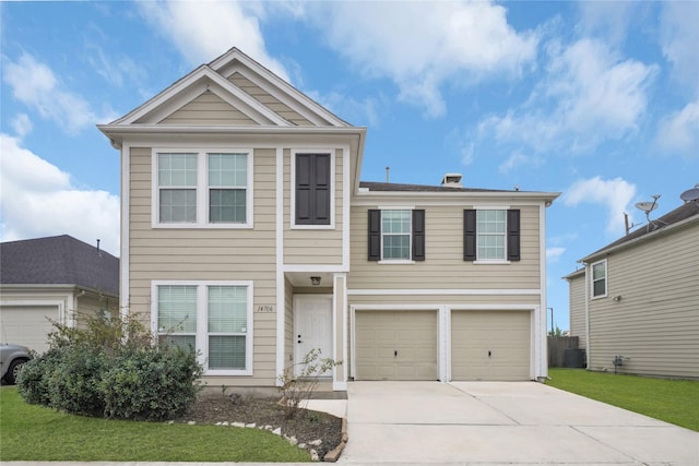 view of front of house featuring a garage and a front lawn