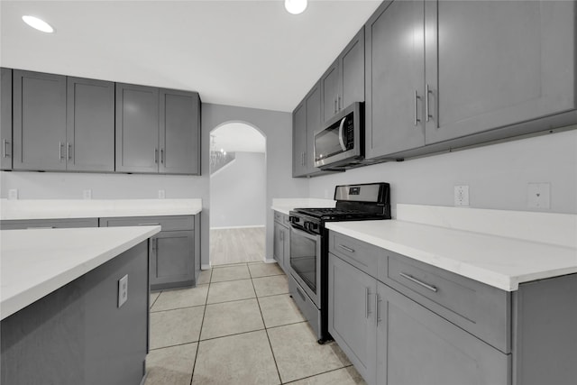 kitchen featuring gray cabinetry, light tile patterned flooring, and stainless steel appliances