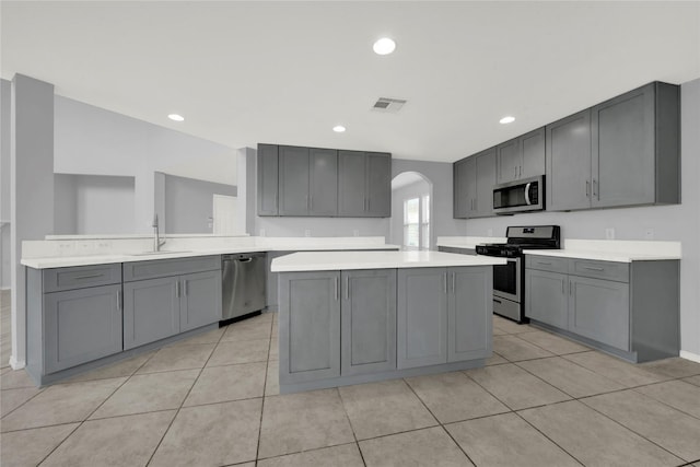 kitchen featuring gray cabinetry, sink, and appliances with stainless steel finishes