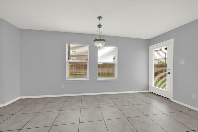 unfurnished room featuring light tile patterned flooring and a healthy amount of sunlight