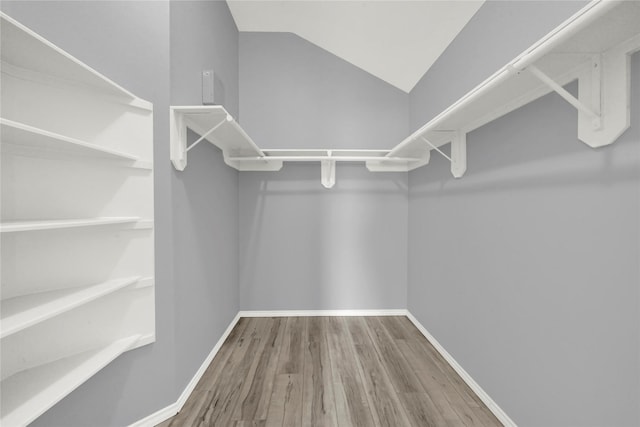 spacious closet with wood-type flooring and lofted ceiling