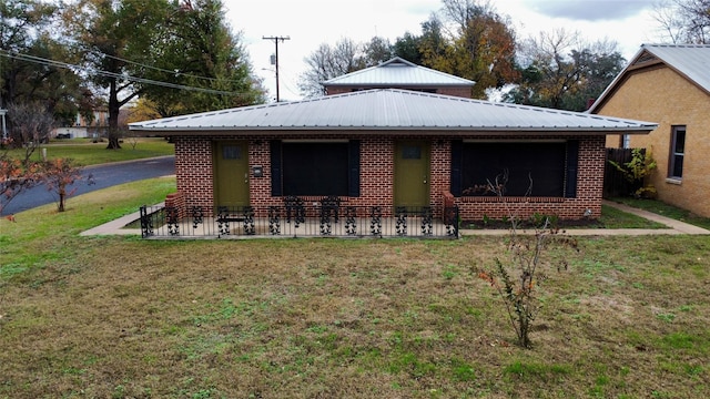 rear view of property featuring a lawn