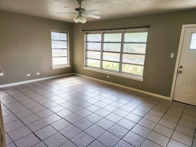 entrance foyer featuring a wealth of natural light, light tile patterned floors, and ceiling fan