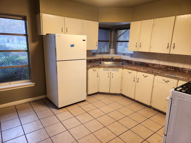 kitchen featuring white appliances, white cabinetry, a wealth of natural light, and sink