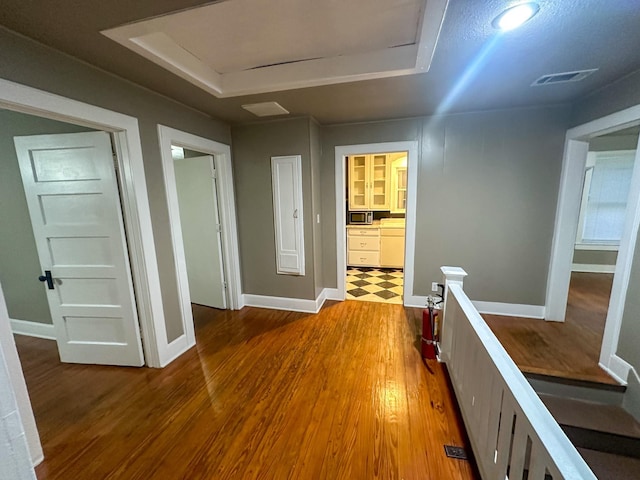 hall with hardwood / wood-style flooring