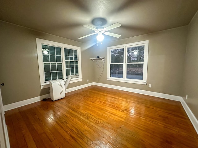 spare room with ceiling fan and wood-type flooring