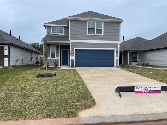 view of property featuring a front yard and a garage