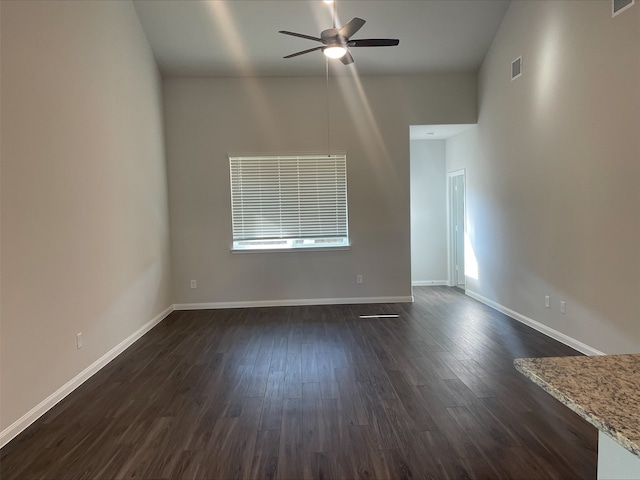 spare room featuring dark hardwood / wood-style flooring and ceiling fan