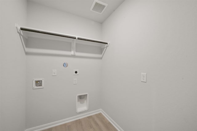 laundry area with hookup for an electric dryer, hookup for a washing machine, gas dryer hookup, and hardwood / wood-style floors