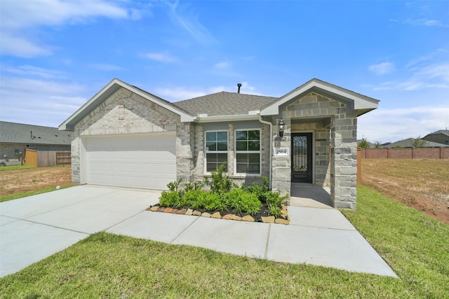 view of front of property with a front yard and a garage