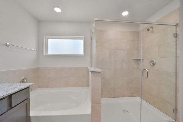 bathroom with vanity and separate shower and tub