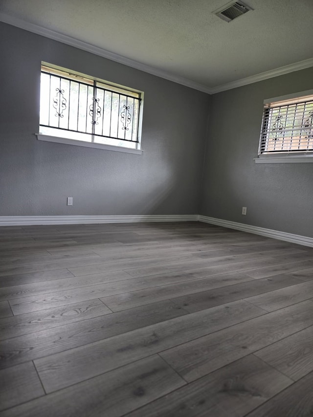 unfurnished room featuring crown molding and hardwood / wood-style floors