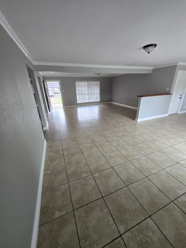 spare room with crown molding and light tile patterned flooring