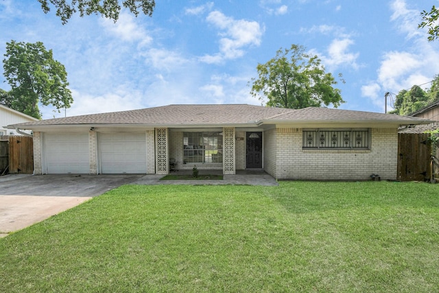 ranch-style home with a garage and a front lawn