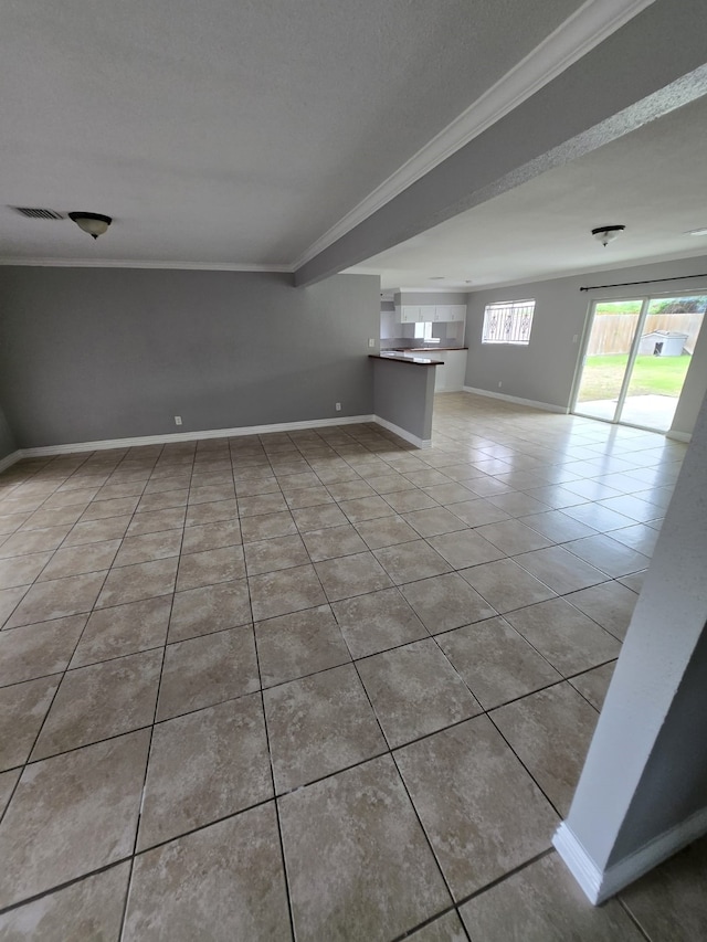 unfurnished room featuring crown molding and light tile patterned flooring