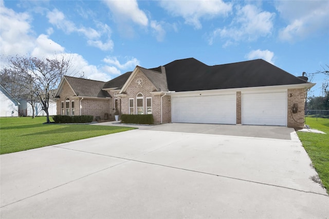 view of front of house featuring a garage and a front lawn