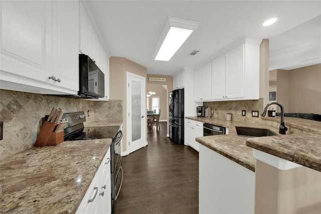 kitchen featuring black appliances, sink, light stone counters, and white cabinetry