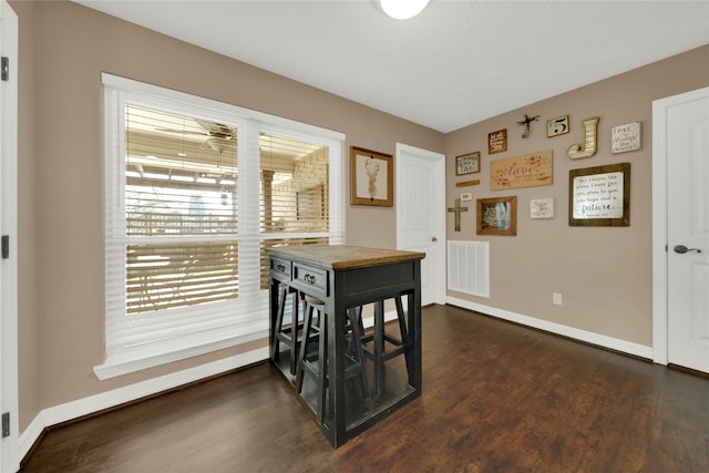 dining area featuring dark wood-type flooring