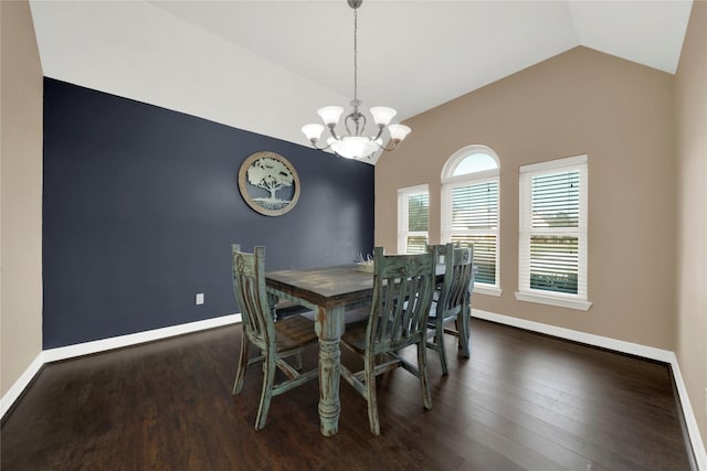 dining room with an inviting chandelier, dark hardwood / wood-style flooring, and lofted ceiling