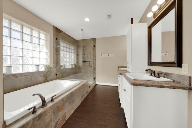 bathroom with separate shower and tub, vanity, and hardwood / wood-style flooring