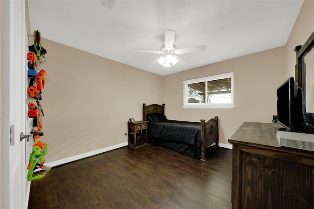 bedroom with ceiling fan and dark hardwood / wood-style floors