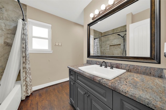 bathroom featuring shower / bath combo with shower curtain, hardwood / wood-style floors, and vanity