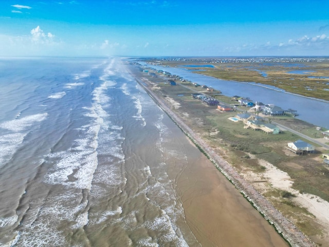 drone / aerial view featuring a beach view and a water view