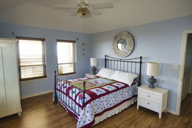 bedroom with ceiling fan and dark wood-type flooring