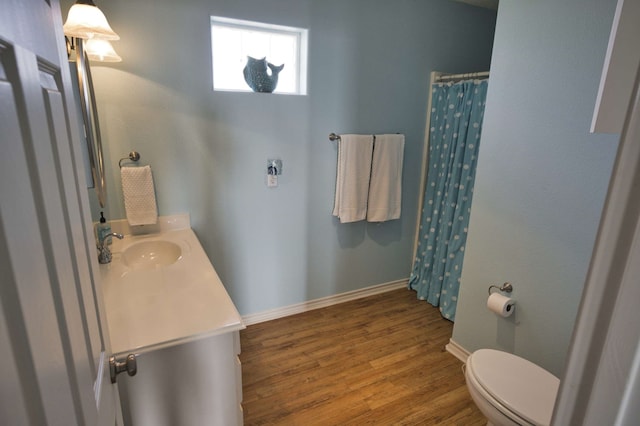 bathroom with hardwood / wood-style flooring, vanity, toilet, and a shower with shower curtain