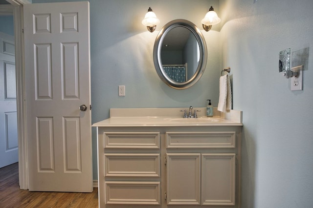 bathroom with hardwood / wood-style floors and vanity