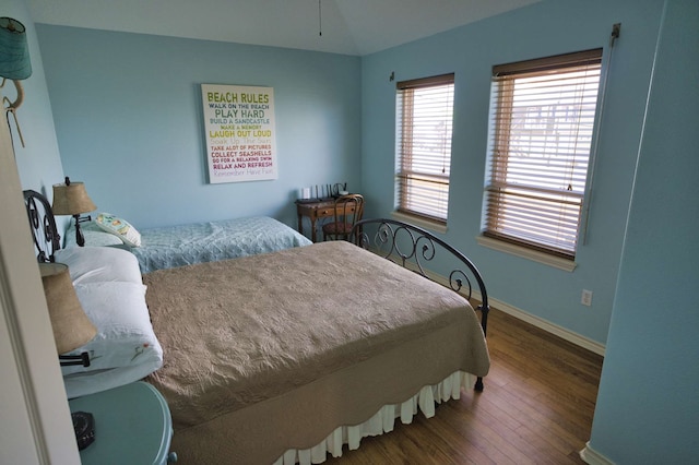 bedroom with lofted ceiling and dark wood-type flooring