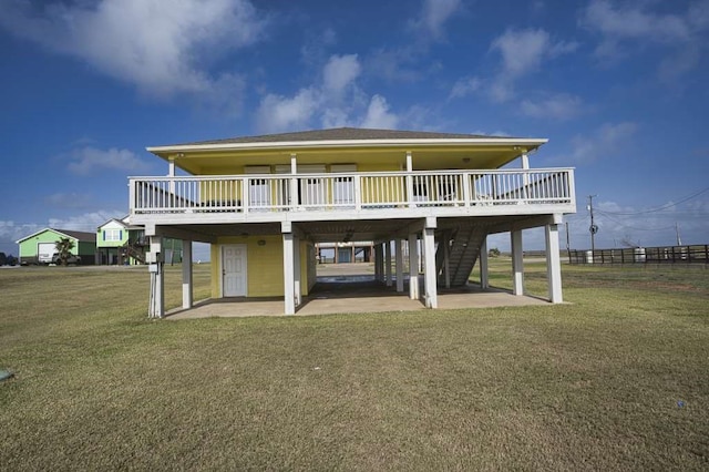 view of front of property featuring a front lawn, a patio area, and a wooden deck