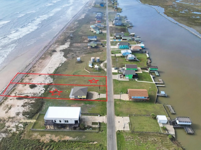 aerial view with a water view and a view of the beach